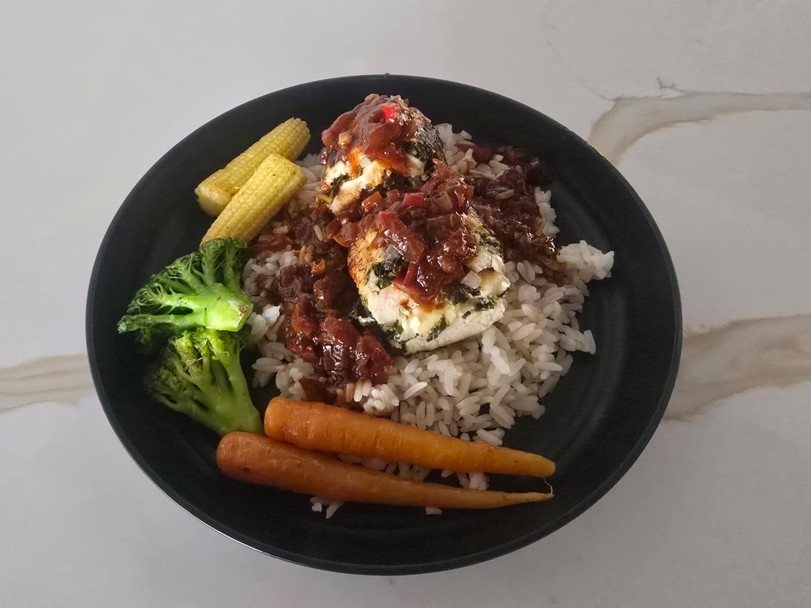 Stuffed chicken over rice and veggies
